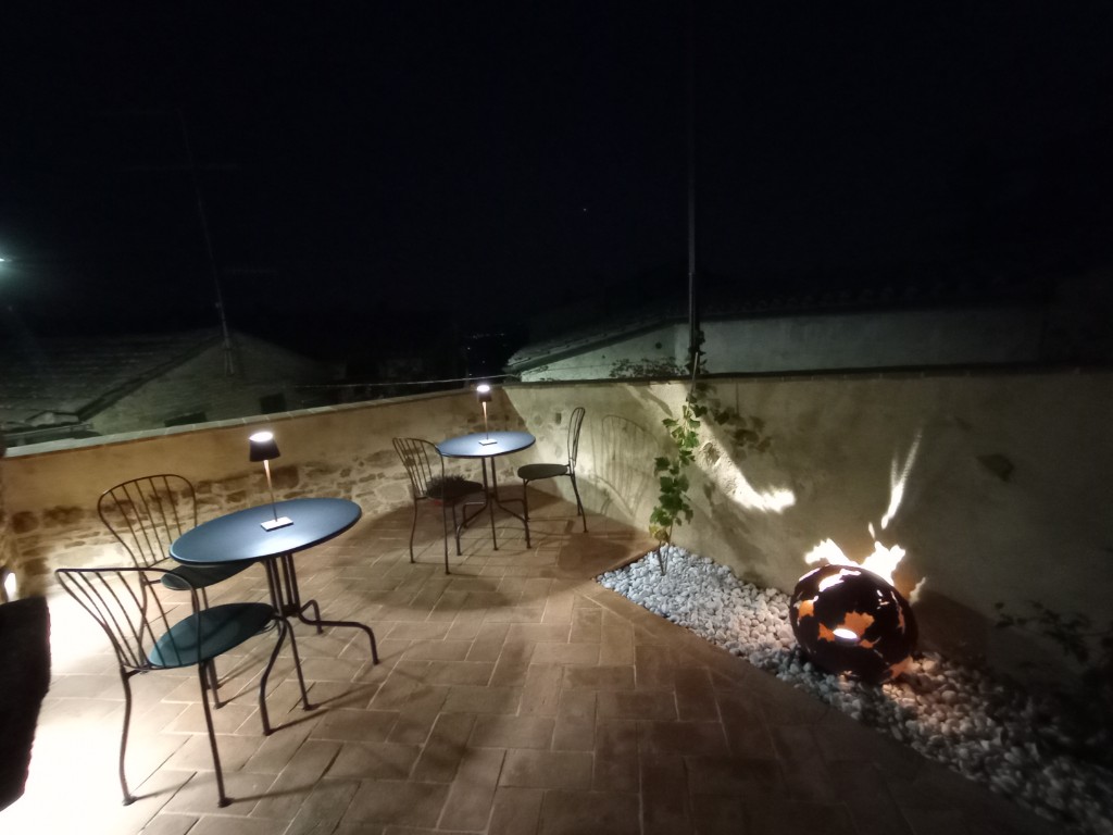 Night courtyard terrace in Montalcino with intimate tables