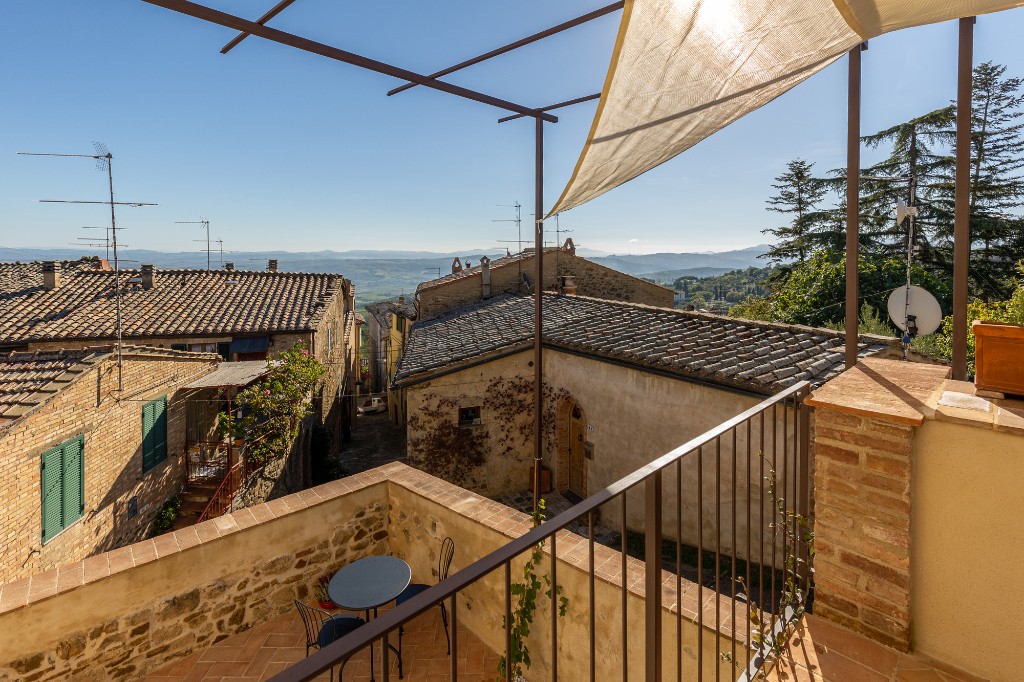 Daytime terrace in Montalcino overlooking rooftops and the Val d Orcia