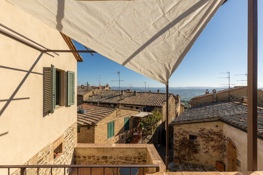 Shaded terrace view over Montalcino rooftops