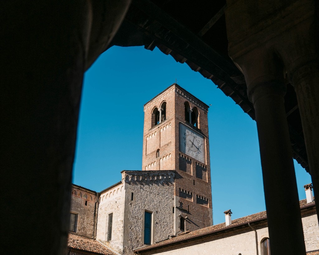 Bell tower of Follina Abbey framed by cloister arches