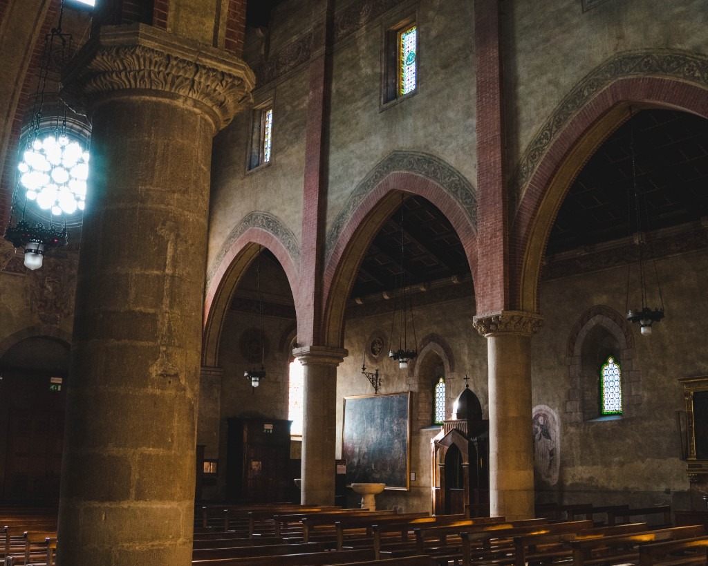 Interior of Follina Abbey church with arches and pews