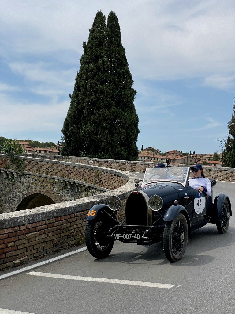 Bugatti vintage racer crossing a stone bridge on the Mille Miglia route - OHH! Italy