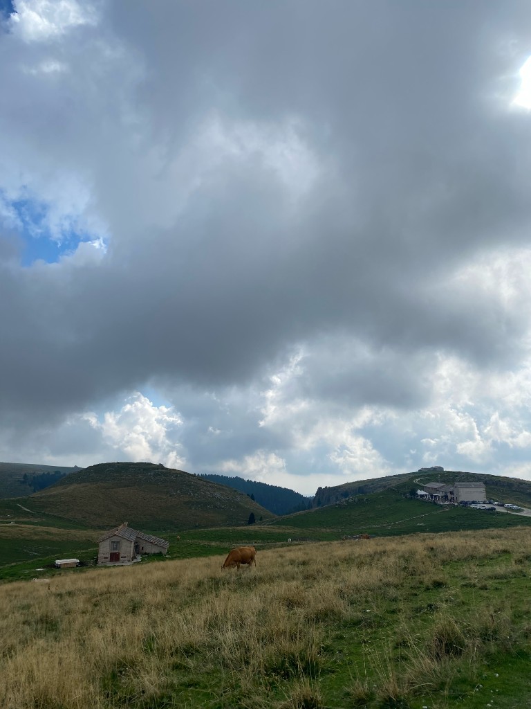 Storm light over pasture and rural buildings in Lessinia