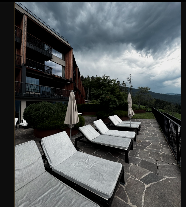 Stone terrace · loungers, greenery and mountain outlook