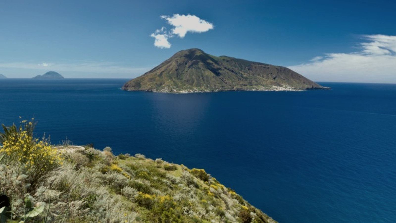 Aeolian Islands and volcanic coastline from the Sicilian sea
