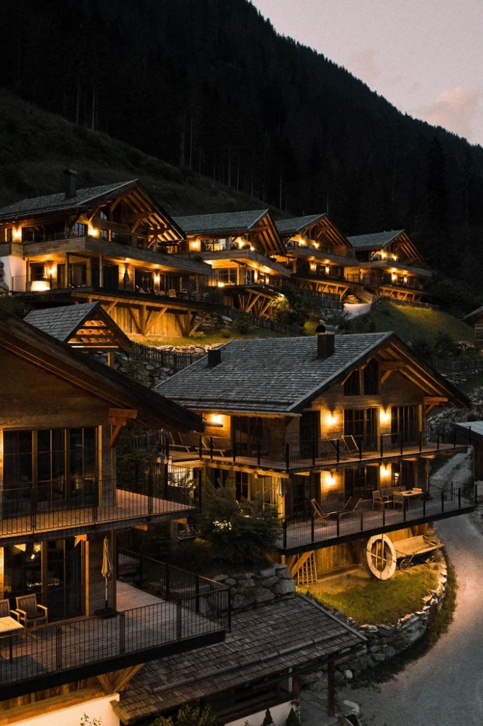 Hillside chalets lit at dusk