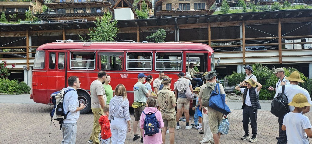 Vintage red bus on a country road · group stay 2024