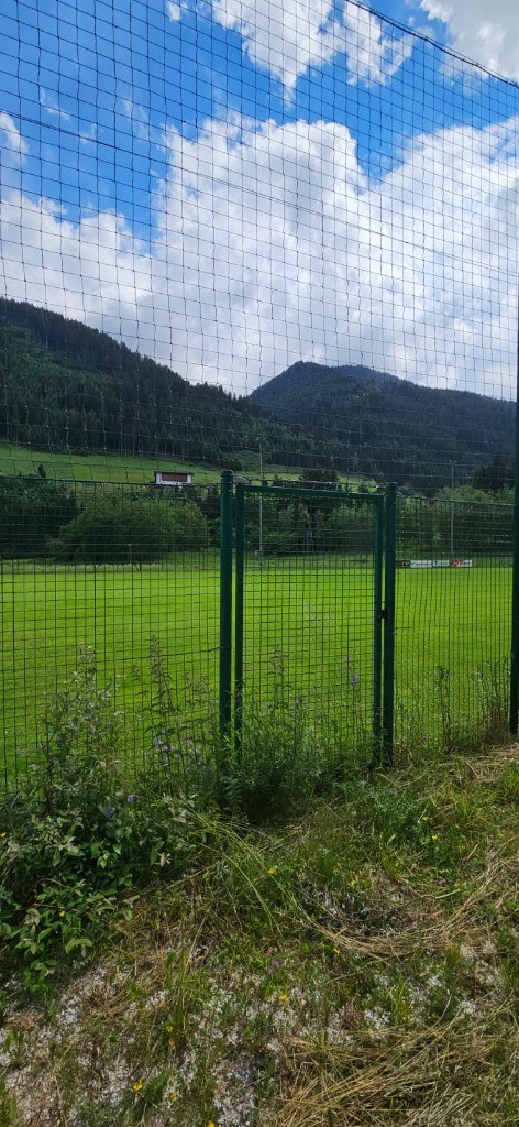 Sports area field with mountain backdrop · Racines 2024