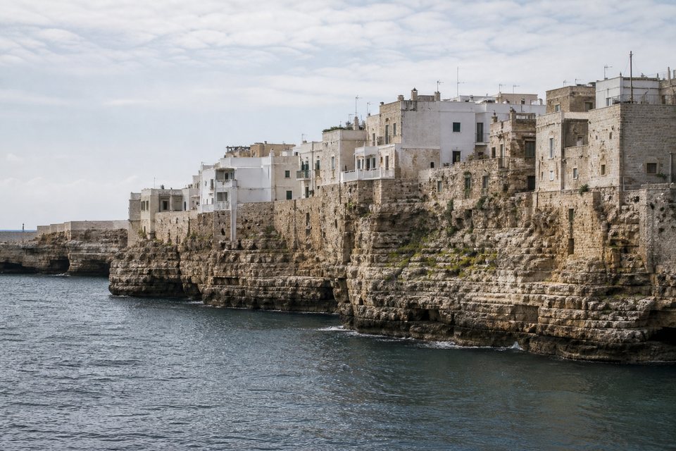 Pale limestone cliff architecture of Polignano a Mare above the Adriatic, Puglia, OHH! ITALY