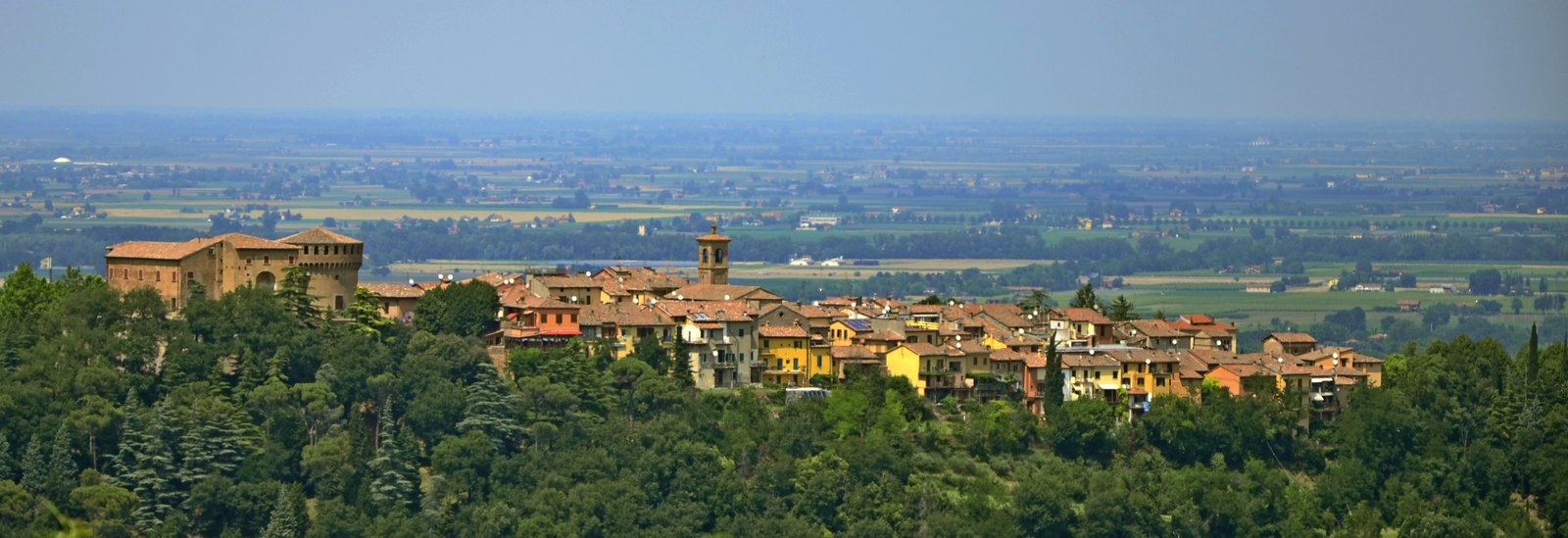 Dozza on its ridge above the plain, the rocca at the left of the roofs.