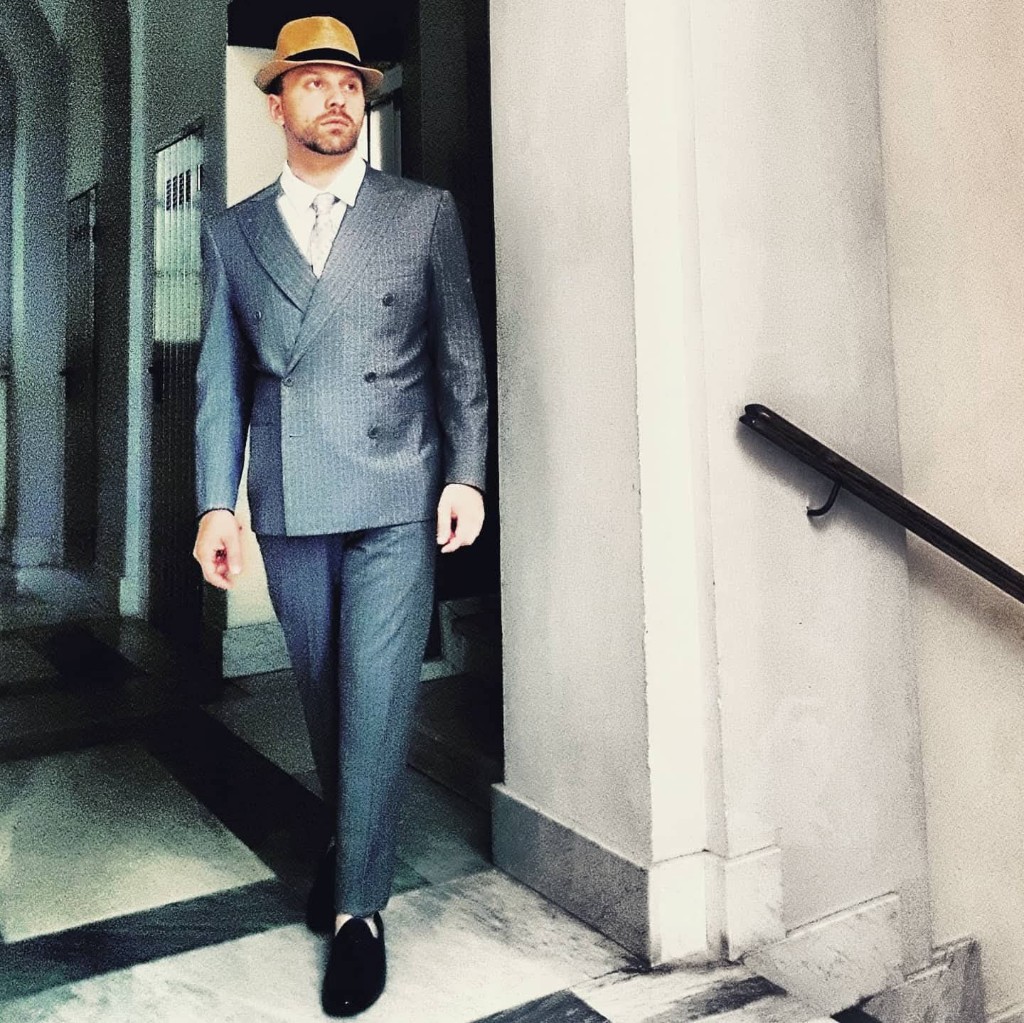 Francesco Caruso in a finished double-breasted suit — the garment in motion