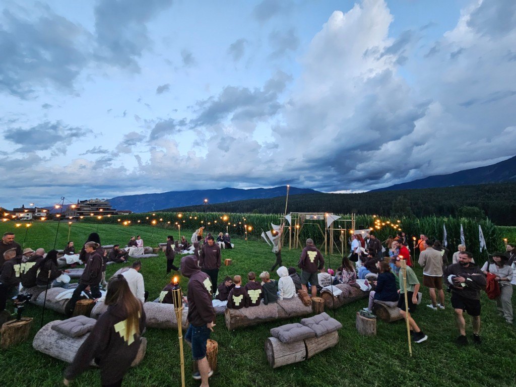 Torch-lit gathering in the field during Summer Camp 2025