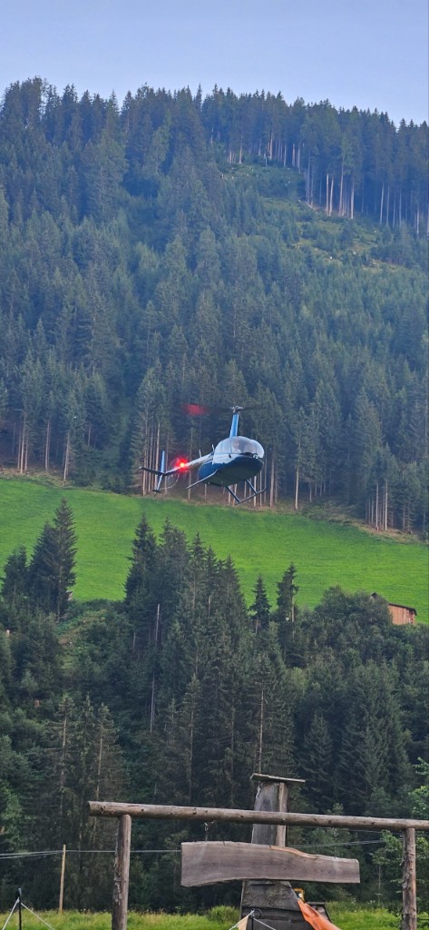 Private helicopter arriving over alpine meadow near a South Tyrol hotel during OHH! ITALY Summer Camp 2024
